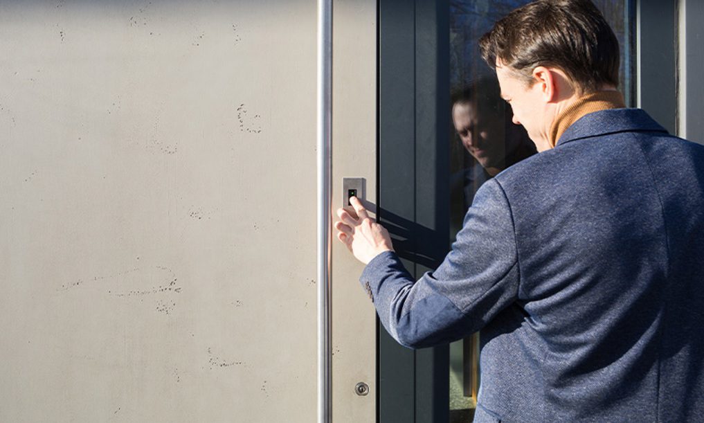 Man pressing doorbell button