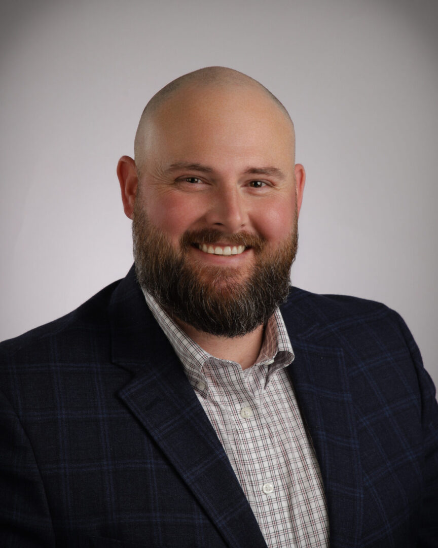 Smiling bald man with beard in suit
