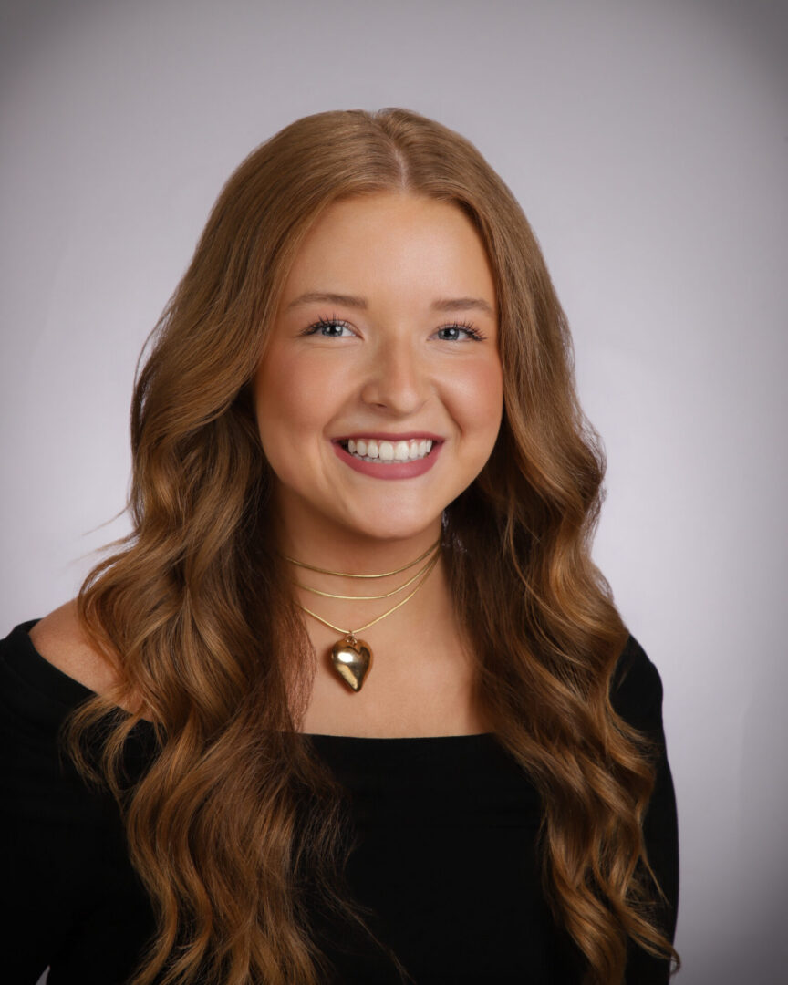 Smiling young woman wearing heart necklace