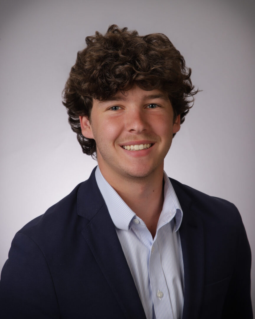 Smiling young man in navy blazer